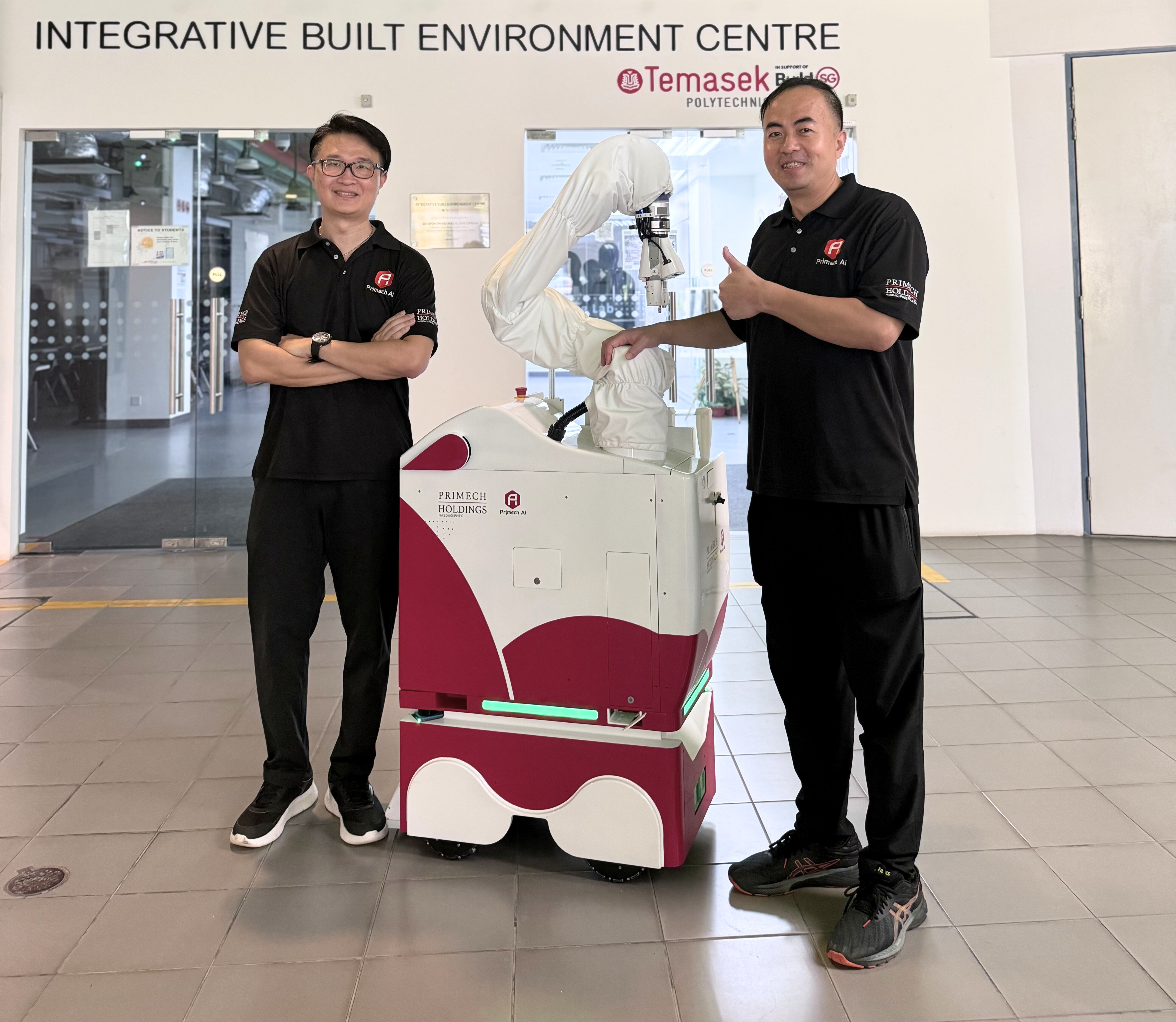 Primech AI's COO, Charles Ng, and CTO, Richard Zhang, proudly commemorate the successful deployment of the Hytron robot at Temasek Polytechnic. Image: Primech AI